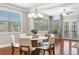 Bright dining room with hardwood floors, modern chandelier, and seating for six at 5115 Edgebrook Dr, Cumming, GA 30040