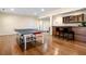 Game room features ping pong table, bar, and hardwood floors at 5115 Edgebrook Dr, Cumming, GA 30040