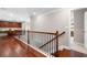 Upstairs hallway with hardwood floors, railing, and built-in cabinetry and countertop at 5115 Edgebrook Dr, Cumming, GA 30040