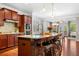 Kitchen island with granite countertops and a bar with seating next to a dining room at 5115 Edgebrook Dr, Cumming, GA 30040