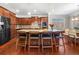 Open-concept kitchen featuring a large central island, barstool seating, and hardwood floors at 5115 Edgebrook Dr, Cumming, GA 30040
