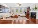 Living room with fireplace and built-ins, large windows, and hardwood floors at 5115 Edgebrook Dr, Cumming, GA 30040