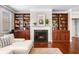 Living room featuring built-in bookcases surrounding a fireplace at 5115 Edgebrook Dr, Cumming, GA 30040