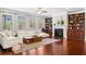 Living room featuring a fireplace with built-in bookcases and large windows at 5115 Edgebrook Dr, Cumming, GA 30040