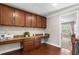 Bright home office featuring custom cabinets, a built-in desk, and hardwood floors at 5115 Edgebrook Dr, Cumming, GA 30040