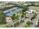 Aerial view of community with tennis courts, a pool, parking, and a playground surrounded by trees at 5309 Davenport Mnr, Cumming, GA 30041