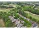 Beautiful aerial view of a residential neighborhood with mature trees and a golf course in the background at 5309 Davenport Mnr, Cumming, GA 30041
