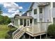 Elevated deck and screened porch offer lovely outdoor living space, with scenic views of manicured lawn and lush landscaping at 5309 Davenport Mnr, Cumming, GA 30041