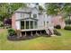 Exterior view of the home from the backyard, highlighting the deck and screened-in porch at 5309 Davenport Mnr, Cumming, GA 30041