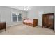 Bedroom with closet, dresser, and bed with storage drawers at 5309 Davenport Mnr, Cumming, GA 30041