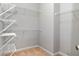 Walk-in closet with adjustable shelving and neutral carpeting at 5309 Davenport Mnr, Cumming, GA 30041