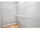Walk-in closet with adjustable shelving and neutral carpeting at 5309 Davenport Mnr, Cumming, GA 30041