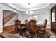 Formal dining room with hardwood floors, detailed trim, and elegant chandelier at 5309 Davenport Mnr, Cumming, GA 30041