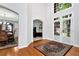 Bright foyer featuring hardwood floors, high ceilings, and access to living spaces at 5309 Davenport Mnr, Cumming, GA 30041