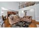 Open-concept living area with soaring ceilings, abundant natural light, and hardwood floors at 5309 Davenport Mnr, Cumming, GA 30041
