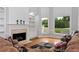 Comfortable living room featuring a fireplace, large windows, and a relaxing atmosphere at 5309 Davenport Mnr, Cumming, GA 30041