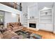 Inviting living room with fireplace, built-in shelving, and an open, airy feel at 5309 Davenport Mnr, Cumming, GA 30041