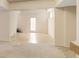 Unfinished basement with tile flooring leading to a door and stairs, offering flexible space at 650 Virginia Highlands, Fayetteville, GA 30215
