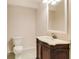 Half bathroom with a classic vanity, decorative mirror, and tiled flooring at 650 Virginia Highlands, Fayetteville, GA 30215