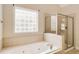 Bathroom features a separate tub and shower with a glass block window at 650 Virginia Highlands, Fayetteville, GA 30215