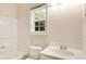 Bright bathroom featuring a tub-shower, a white toilet, and a white vanity with modern fixtures at 650 Virginia Highlands, Fayetteville, GA 30215