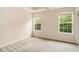 Bright bedroom has two windows, neutral walls and carpet, and a ceiling fan at 650 Virginia Highlands, Fayetteville, GA 30215