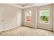 Cozy bedroom features neutral walls and carpet, plus two sunny windows at 650 Virginia Highlands, Fayetteville, GA 30215