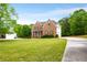 Charming two-story brick home with manicured lawn and lush landscaping at 650 Virginia Highlands, Fayetteville, GA 30215