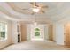 Spacious main bedroom with fireplace, tray ceilings, ceiling fans, and a large window with natural light at 650 Virginia Highlands, Fayetteville, GA 30215