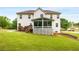 Back of home featuring a screened-in porch, patio, and a spacious green lawn at 650 Virginia Highlands, Fayetteville, GA 30215