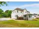 Charming home with a well-maintained lawn, a screened-in porch, and mature trees in a serene backyard setting at 650 Virginia Highlands, Fayetteville, GA 30215