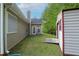 View of backyard featuring the exterior of the home and a storage shed with ramp at 152 Cooper Creek Dr, Dallas, GA 30157