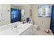Bright bathroom with a single sink vanity and a large mirror providing natural light at 152 Cooper Creek Dr, Dallas, GA 30157