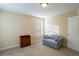 Cozy bedroom with a comfortable sofa, neutral walls, carpet, and a large window at 152 Cooper Creek Dr, Dallas, GA 30157