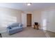 Bright bedroom with a comfortable sofa, neutral walls, carpet, and a large window at 152 Cooper Creek Dr, Dallas, GA 30157