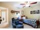 Cozy bedroom featuring a ceiling fan and a blue recliner providing natural light at 152 Cooper Creek Dr, Dallas, GA 30157