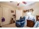 Bedroom featuring a ceiling fan, blue chair and a shelf full of stuffed bears at 152 Cooper Creek Dr, Dallas, GA 30157