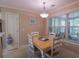 Cozy breakfast nook features a light wood table, white chairs, and a bright window at 152 Cooper Creek Dr, Dallas, GA 30157
