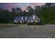 Inviting single-Gathering home at twilight with well-maintained landscaping and a serene, peaceful setting at 152 Cooper Creek Dr, Dallas, GA 30157