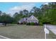 Beautifully landscaped front yard with lush greenery and a charming single-Gathering home at 152 Cooper Creek Dr, Dallas, GA 30157