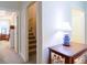 View of hallway featuring access to staircase, bedroom, and a display cabinet at 152 Cooper Creek Dr, Dallas, GA 30157