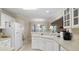 Well-lit kitchen featuring white cabinets and ample countertop space for cooking at 152 Cooper Creek Dr, Dallas, GA 30157