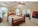 Spacious main bedroom with a tray ceiling, archway to a sitting area, and ample natural light at 152 Cooper Creek Dr, Dallas, GA 30157