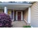Charming front porch with classic columns, a wreath on the door, and manicured landscaping at 152 Cooper Creek Dr, Dallas, GA 30157