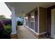 Inviting covered front porch with classic columns, decorative shutters, and tasteful landscaping at 152 Cooper Creek Dr, Dallas, GA 30157