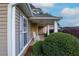 Relaxing front porch featuring a charming rocking chair and beautifully maintained landscaping at 152 Cooper Creek Dr, Dallas, GA 30157
