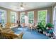 Cozy sunroom with wicker furniture, ceiling fan, and lots of natural light at 152 Cooper Creek Dr, Dallas, GA 30157