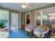 Relaxing sunroom with wicker seating, ceiling fan, and views of the backyard at 152 Cooper Creek Dr, Dallas, GA 30157