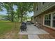 Spacious backyard featuring a patio, mature trees, and well-maintained lawn at 387 Cascade Sw Dr, Lilburn, GA 30047