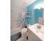 Updated bathroom with shower, modern vanity, and blue accent wall at 387 Cascade Sw Dr, Lilburn, GA 30047